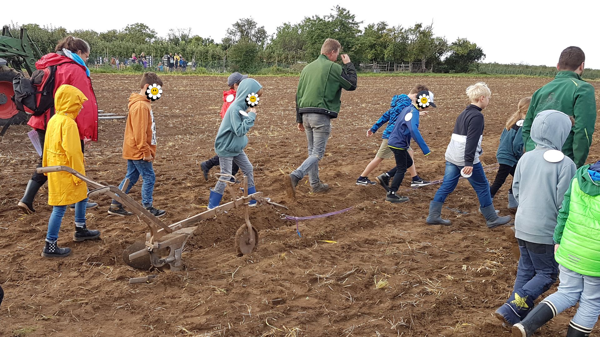 Kinder mit Handpflug auf dem Feld